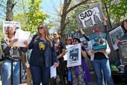 A photo of NhRP Attorney Liddy Stein speaking at a rally to free Happy from the Bronx Zoo as rally attendees listen and hold signs