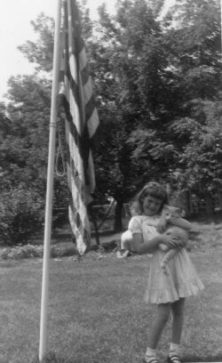 Jean Colison and her cat Sandy in the backyard of her childhood home.