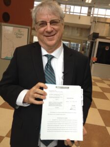 A photo of Steven M. Wise smiling as he displays the NhRP's first habeas corpus petition.