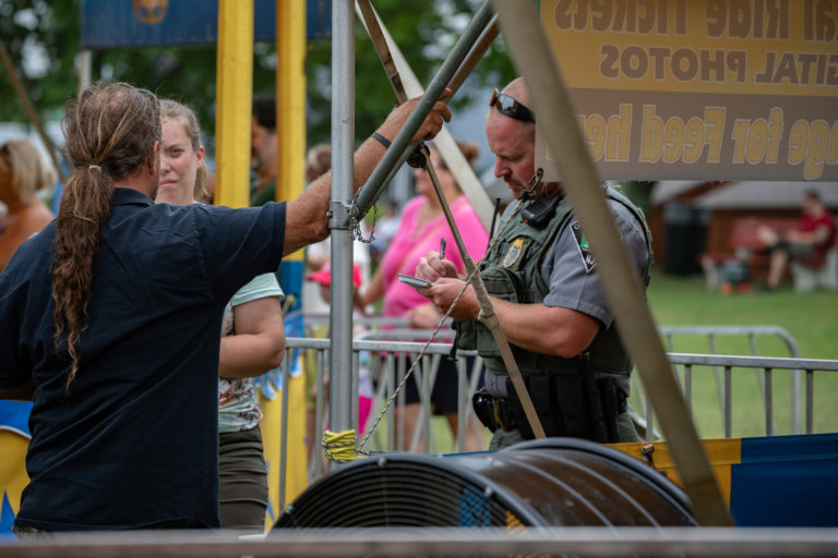 Officials with New Jersey Division of Fish and Wildlife talk to Tim Commerford of the Commerford Zoo at the NJ State Fair about potential violations of Nosey's Law