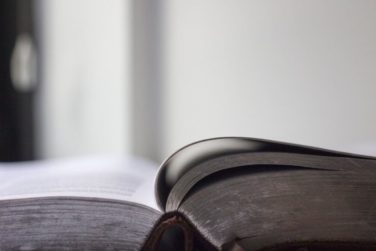 An open book lying flat on a table.